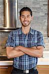 Portrait of a handsome young man with arms crossed