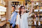 Happy young couple browsing for fixtures in lights store