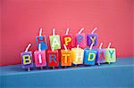 Unlit birthday candles over colored background