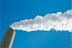smoking industrial chimney against a blue sky