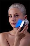 Young woman getting photo-therapy treatment with blue light