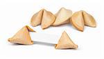Broken fortune cookie with fortune paper in front of a few other cookies isolated on white.