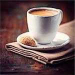 cup of espresso crema and biscotti ( focus on biscotti)
