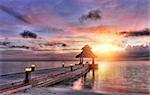 Vivid sunset over the jetty in the Indian ocean, Maldives.