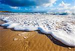 Waves wash over golden sand on Australian beach