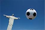 Soccer ball football floats in bright blue sky at Corcovado Rio de Janeiro