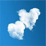 Two heart-shaped clouds on blue sky background.  Valentine's Day
