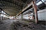 Old and deserted plant interior with weathered walls and overlap