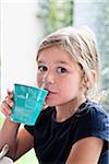 Girl Drinking from Blue Cup