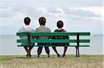 Back View of Mother and Sons Sitting on Park Bench, Ile de Re, France