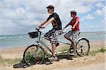 Brothers Riding Tandem Bicycle on Beach, Ile de Re, France