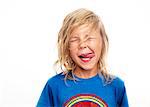 Portrait of boy sticking out tongue, studio shot