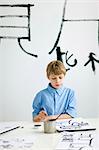 Boy and caligraphing chinese signs