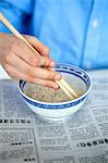 Close up of boys hand holding chopsticks