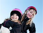 Portrait de deux soeurs portant des casques de ski
