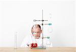 Scientist observing beaker on workbench