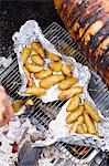 Potatoes in aluminum foil on grill