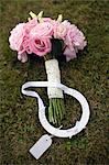 Wedding bouquet and horseshoe on grass