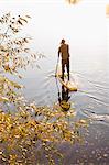 Man rowing paddle board in water