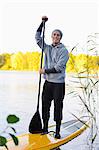 Portrait of man on paddle board in water