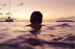 Silhouette of man swimming in sea