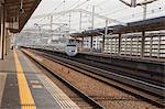 A bullet train passes Hemeji Station, Hyogo Prefecture, Japan