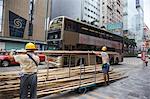 Workers arranging bamboos for scaffolding on Nathan Road, Kowloon, Hong Kong