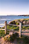 Wooden stile on Cornish clifftops near Porthcothan Bay with views to Trevose Head, Cornwall, England, United Kingdom, Europe