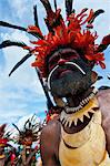 Colourfully dressed and face painted local tribesman celebrating the traditional Sing Sing in the Highlands of Papua New Guinea, Pacific