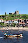 Pleasure ship below Whitby Abbey and St. Marys Church, Whitby, North Yorkshire, Yorkshire, England, United Kingdom, Europe