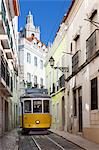 Tram (electricos) along Rua das Escolas Gerais with tower of Sao Vicente de Fora, Lisbon, Portugal, Europe