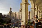 Woman taking photograph of Arequipa Cathedral (la catedral) Plaza de Armas, Arequipa, peru, peruvian, south america, south american, latin america, latin american South America