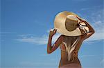 Woman wearing sunhat and bikini