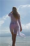 Woman walking in still ocean water