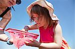 Mother and daughter fishing with net