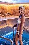 Woman standing in modern indoor pool