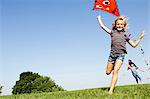 Girls playing with kites outdoors