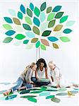 Girls talking under tree on wall