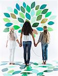 Girls writing on tree on wall