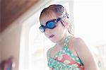 Girl wearing goggles by pool