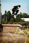 Man skating on grassy wall