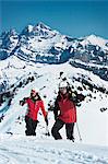 Skiers climbing snowy mountainside