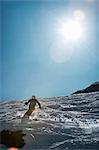 Skier coasting on snowy slope