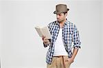 Man reading book with hand in pocket