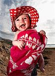Infant laughing on beach
