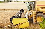 Thresher working in crop field