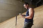 Man using tablet computer in grain