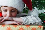 Boy resting head on Christmas present