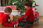 Young brother and sister opening Christmas gift together