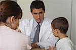 Doctor talking with little boy and woman